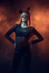 Portrait of beautiful cyber model woman posing wearing led glasses on head with neon light in a virtual tech environment