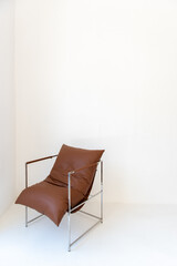 Brown chair in a white room
