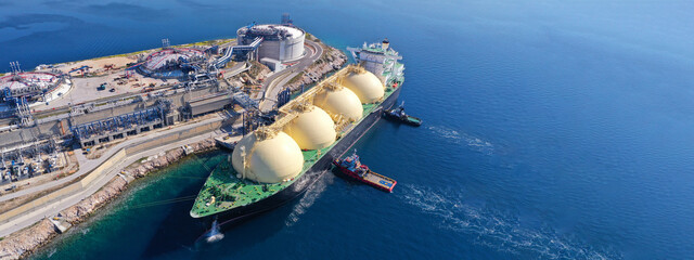 Fototapeta Aerial drone ultra wide panoramic photo with copy space of LNG (Liquified Natural Gas) tanker anchored in small gas terminal island with tanks for storage obraz