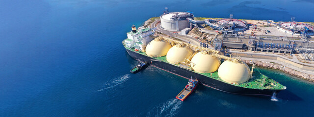 Aerial drone ultra wide photo of LNG (Liquified Natural Gas) tanker anchored in small LNG...