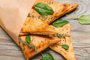 Tasty Uzbek samsa on wooden background