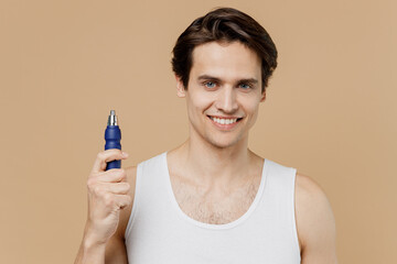 Attractive happy young man 20s perfect skin in undershirt hold in hand electric hair cutter trimmer...