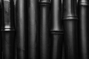 Black bamboo sticks as background, closeup