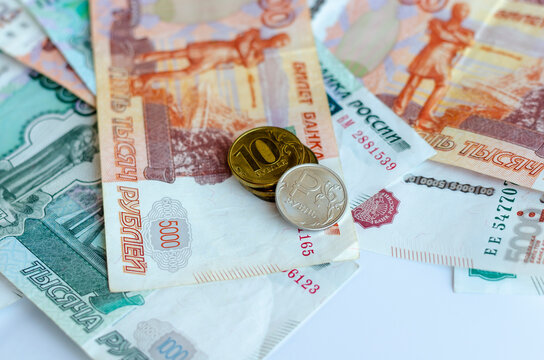 A coin with a ruble sign lies on Russian money. Concept of finance, investment, savings and cash 