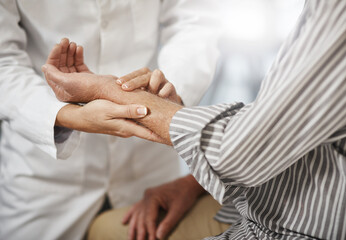 Lets check your pulse. Cropped shot of an unrecognizable female doctor taking a male patients pulse during a consultation.