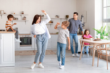 Happy  family dancing in kitchen