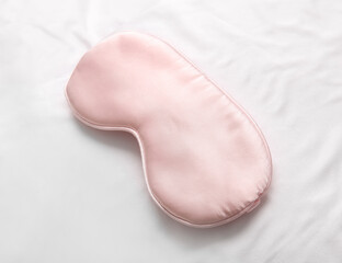 Sleep mask on light fabric background