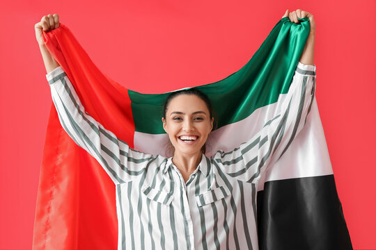 Beautiful woman with UAE flag on red background
