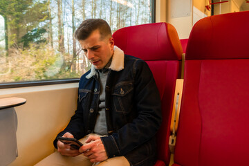 Man traveling by train to work. Talking on the phone