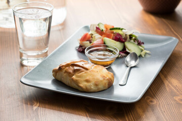 Chicken pie served with salad and sauce