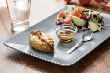 Chicken pie served with salad and sauce