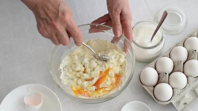Process of making dough cake. woman&rsquo;s hands mix flour and eggs, on the side stand milk and in bowl sugar on white table. ingredients for baking cake in kitchen, recipe. Top View.