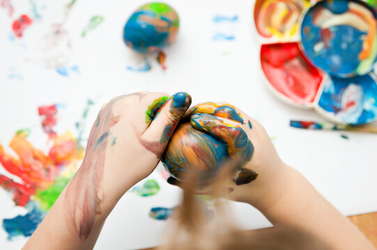 Happy Easter. 3 years boy painting Easter eggs. Religious holiday. Early education and artistic pre-school activities.
