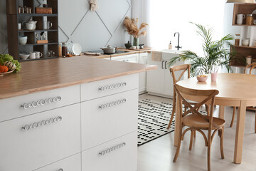 White kitchen table with drawers in modern room