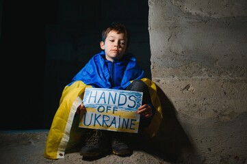 Naklejka na ściany i meble War of Russia against Ukraine. Ukrainian Crying boy asks to stop the war in Ukraine. Child with message Stop War.