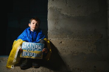 Naklejka na ściany i meble Young child, holding sign in support to peace, no war wanted, kid wishing peaceful life. Picture in connection with the continuing war in Ukraine