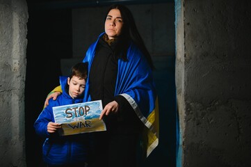 KYIV, UKRAINE - Mar. 21, 2022: War in Ukraine. Life in a bomb shelter. Young mother with a child in...