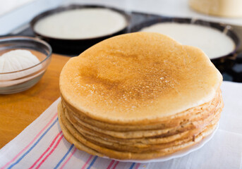 cooking traditional pancakes from wheat flour in the kitchen