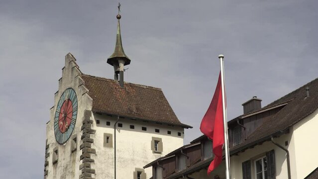 Swiss flag waving in Lucerne city. Low angle and static view