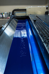 Color and glossy rollers of offset printing machine. offset ink colour.  Cyan. Photo taken...