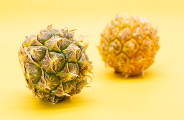 fresh pineapple isolated on yellow background, healthy fruit with vitamin c.