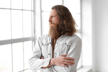 Portrait of handsome bearded man at home