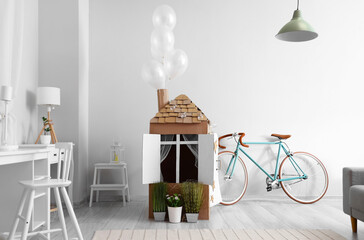 Cardboard toy house for child in room