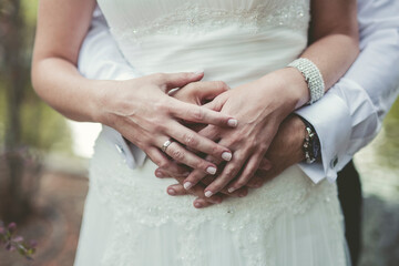 Plano de manos entrelazadas de novios durante una boda. 
Concepto amor, novios y día de boda. 