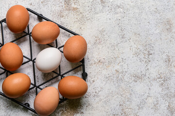 Grid with fresh chicken eggs on light background, closeup