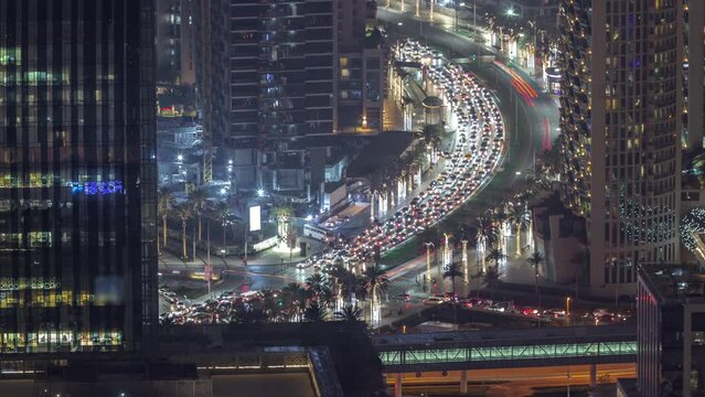Bussy traffic on the intersection in Dubai downtown aerial night timelapse.