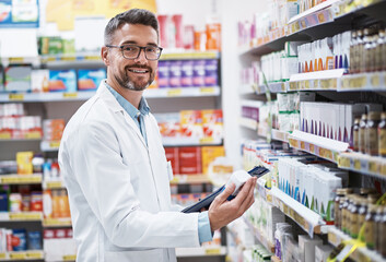 Fototapeta na wymiar Weve got a brand new range of stock in. Portrait of a mature pharmacist doing inventory in a pharmacy.