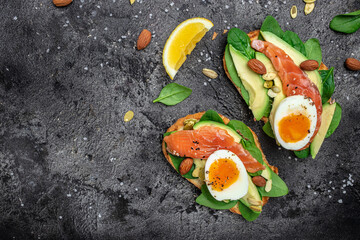 Fototapeta na wymiar Delicious breakfast or snack whole grain bread with avocado paste and salmon. keto paleo diet. banner, menu, recipe place for text, top view