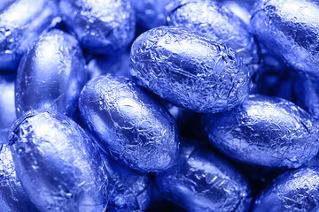 Tasty chocolate eggs in color foil, closeup