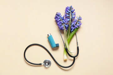 Composition with inhaler, stethoscope and beautiful hyacinth flowers on color background