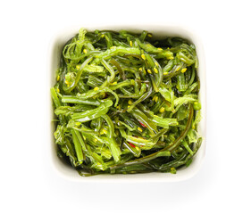 Bowl with healthy seaweed salad on white background