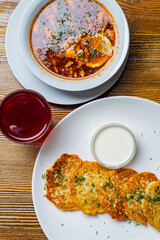 Pieces of chop (schnitzel), toast with eggs, fresh tomato on a wooden board on a dark background....