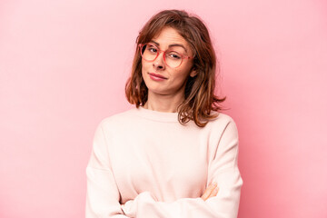 Young caucasian woman isolated on pink background unhappy looking in camera with sarcastic...