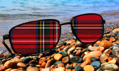 Gaelic tartan of red, white, green and yellow imposed on sunglass lenses