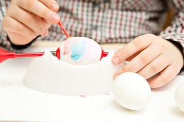 Happy Easter. Boy painting Easter eggs. Religious holiday. Early education and artistic preschool activities. Child having fun and celebrating feast.