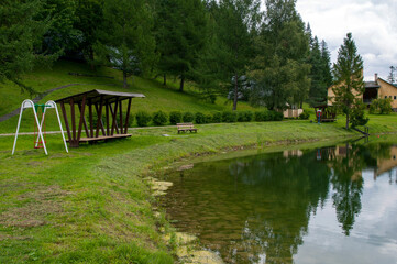 A place of rest in the mountains, green forest and peaks.