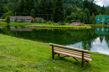 A place of rest in the mountains, green forest and peaks.