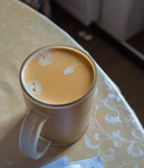 glass of coffee with milk on the table close-up