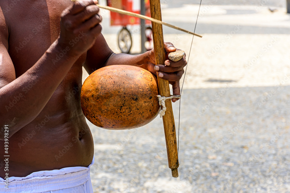 Wall mural musicians playing traditional instruments used in capoeira, a mix of fight and dance from afro-brazi