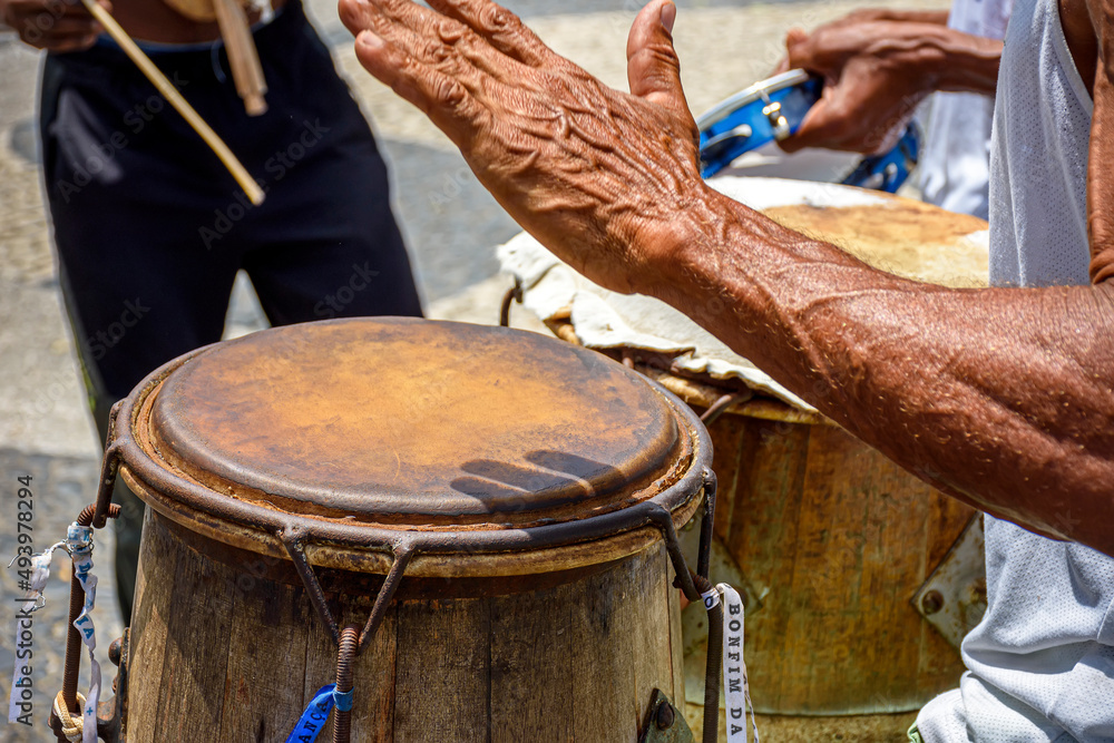 Wall mural Musicians playing traditional instruments used in capoeira, a mix of fight and dance from Afro-Brazilian culture in the streets of Pelourinho in Salvador, Bahia