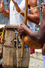 Musicians playing traditional instruments used in capoeira, a mix of fight and dance from Afro-Brazilian culture in the streets of Pelourinho in Salvador, Bahia - obrazy, fototapety, plakaty