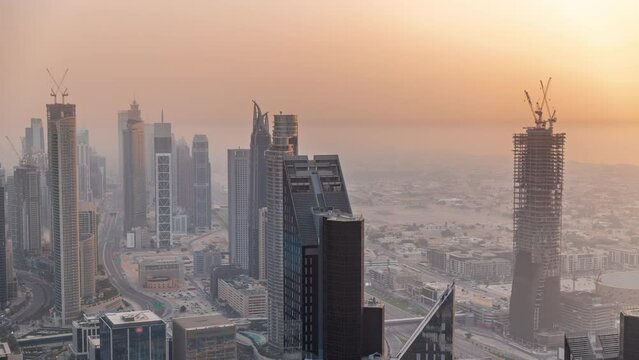 Downtown skyline with modern architecture form above timelapse. Aerial view of Dubai business bay towers.