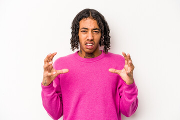 Young African American man isolated on white background screaming with rage.