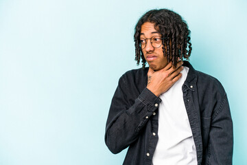 Young African American man isolated on blue background touching back of head, thinking and making a choice.