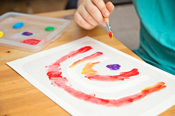 A different rainbow. Boys drawing with gouache. Children activities for raining day.