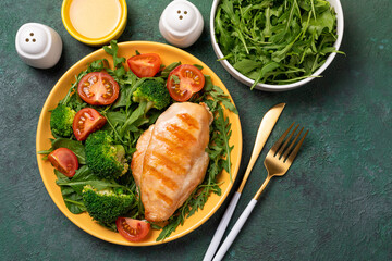 Chicken fillet with fresh vegetable salad. Chicken breast and green vegetables, broccoli on table. Healthy lunch menu